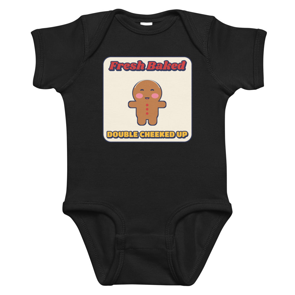 Double Cheeked Up Fresh Baked Gingerbread Baby Onesie in black, mockup of the design printed on the front of the baby onesie