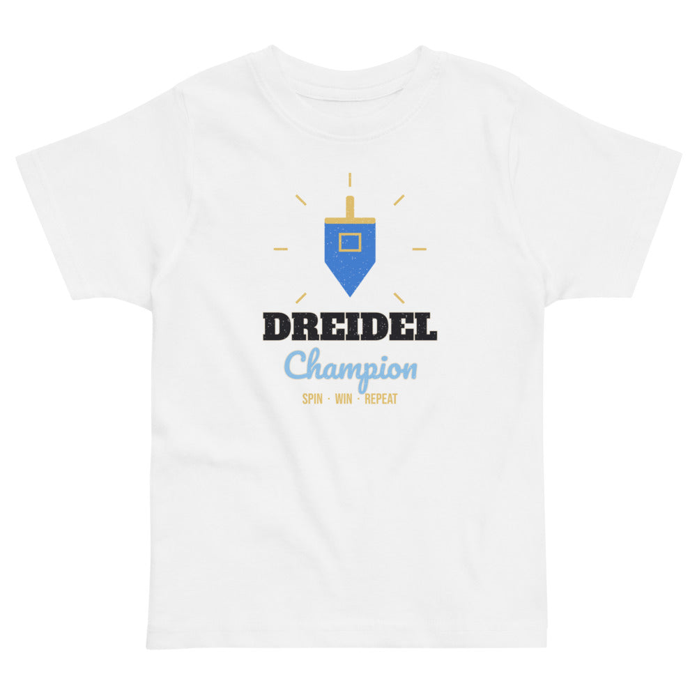 Dreidel Champion Toddler Tee in white, mockup of the design printed on the front of the toddler tee