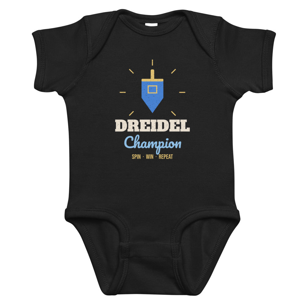 Dreidel Champion Baby Onesie in black, mockup of the design printed on the front of the baby onesie