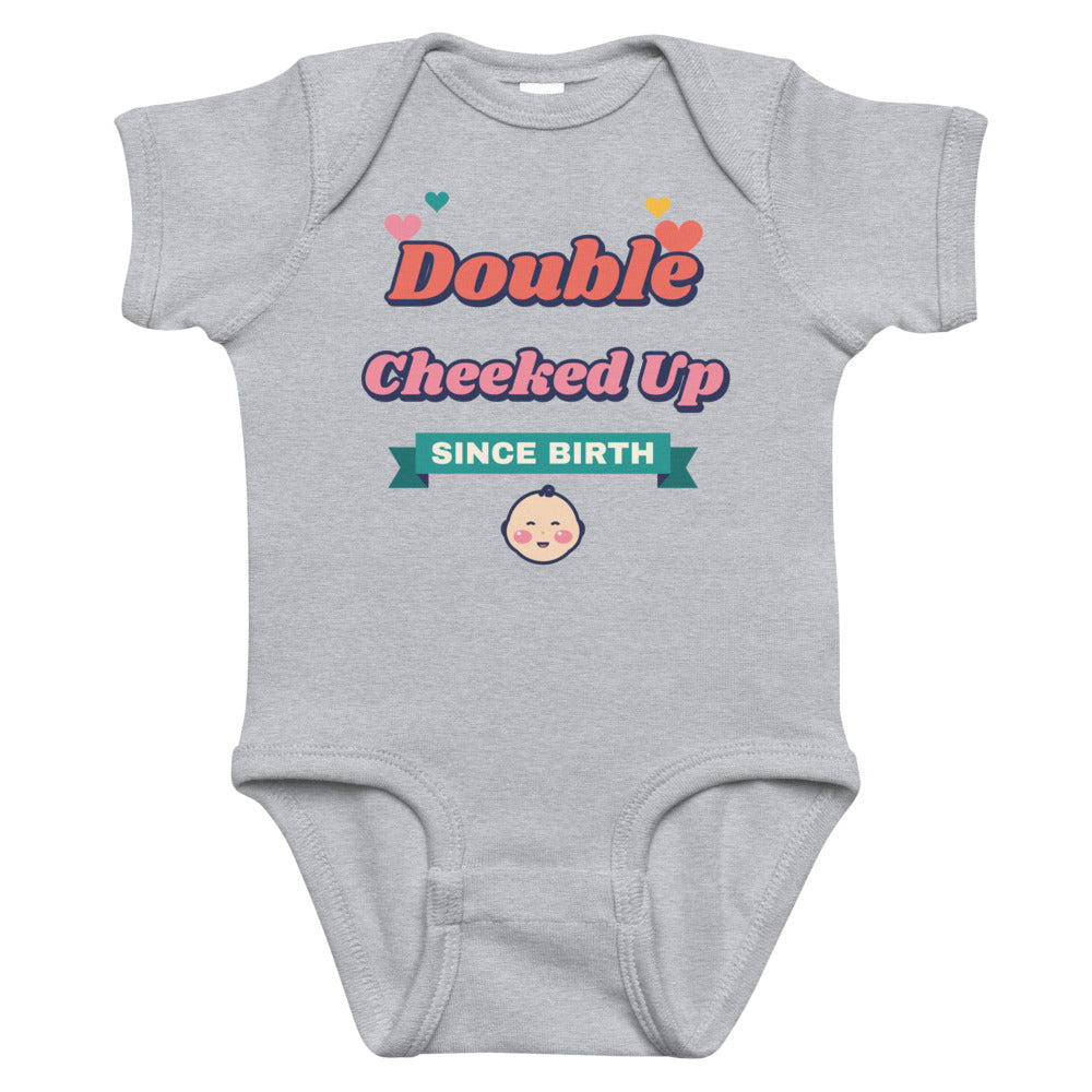 Double Cheeked Up Since Birth Baby Onesie in heather, mockup of the design printed on the front of the baby onesie