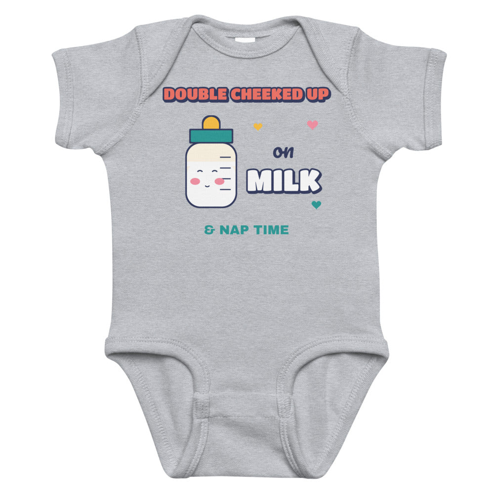 Double Cheeked Up on Milk Baby Onesie in heather, mockup of the design printed on the front of the baby onesie
