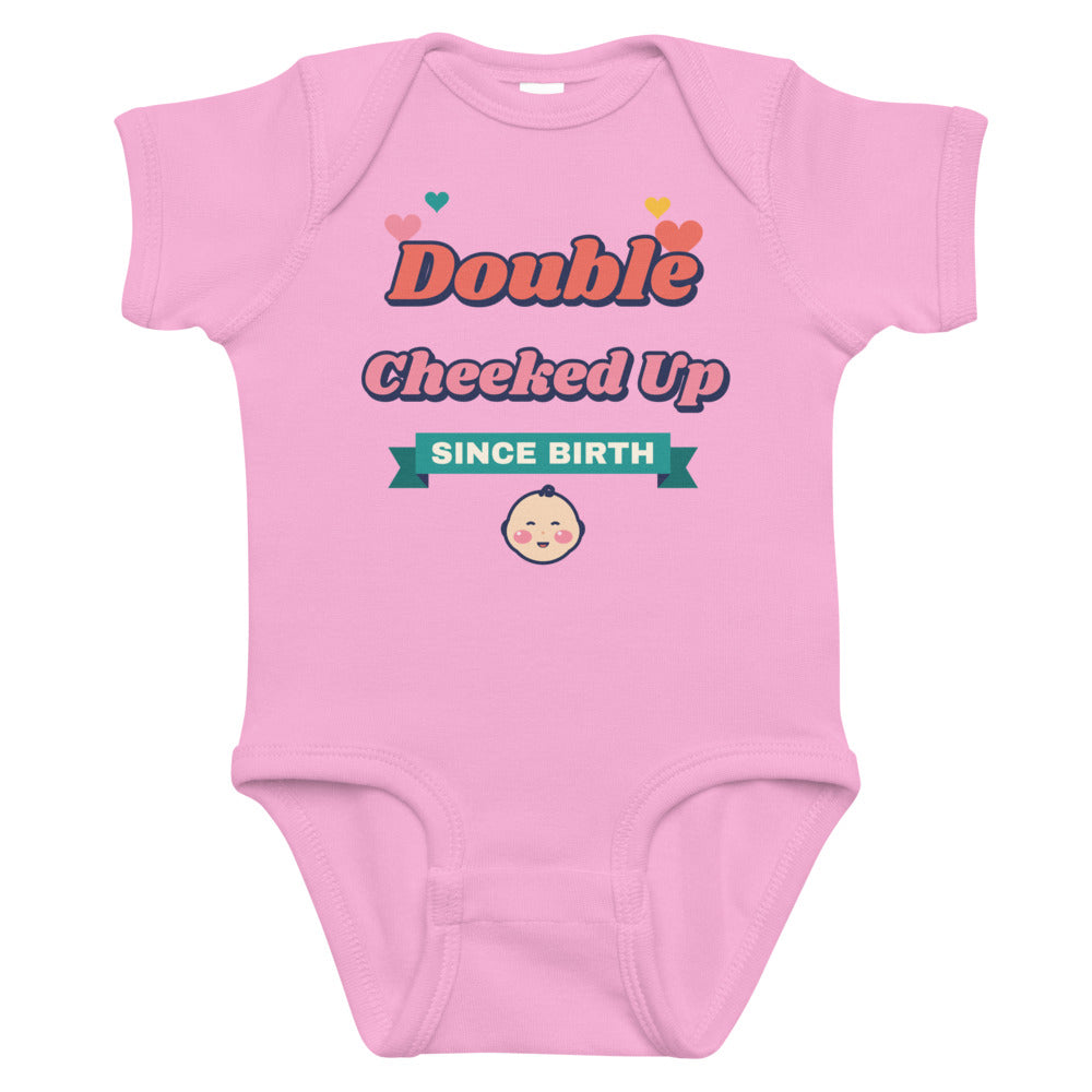 Double Cheeked Up Since Birth Baby Onesie in pink, mockup of the design printed on the front of the baby onesie