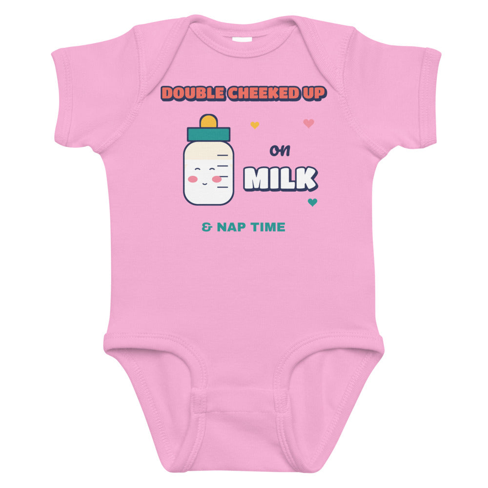 Double Cheeked Up on Milk Baby Onesie in pink, mockup of the design printed on the front of the baby onesie