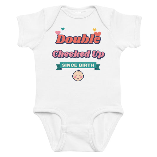 Double Cheeked Up Since Birth Baby Onesie in white, mockup of the design printed on the front of the baby onesie