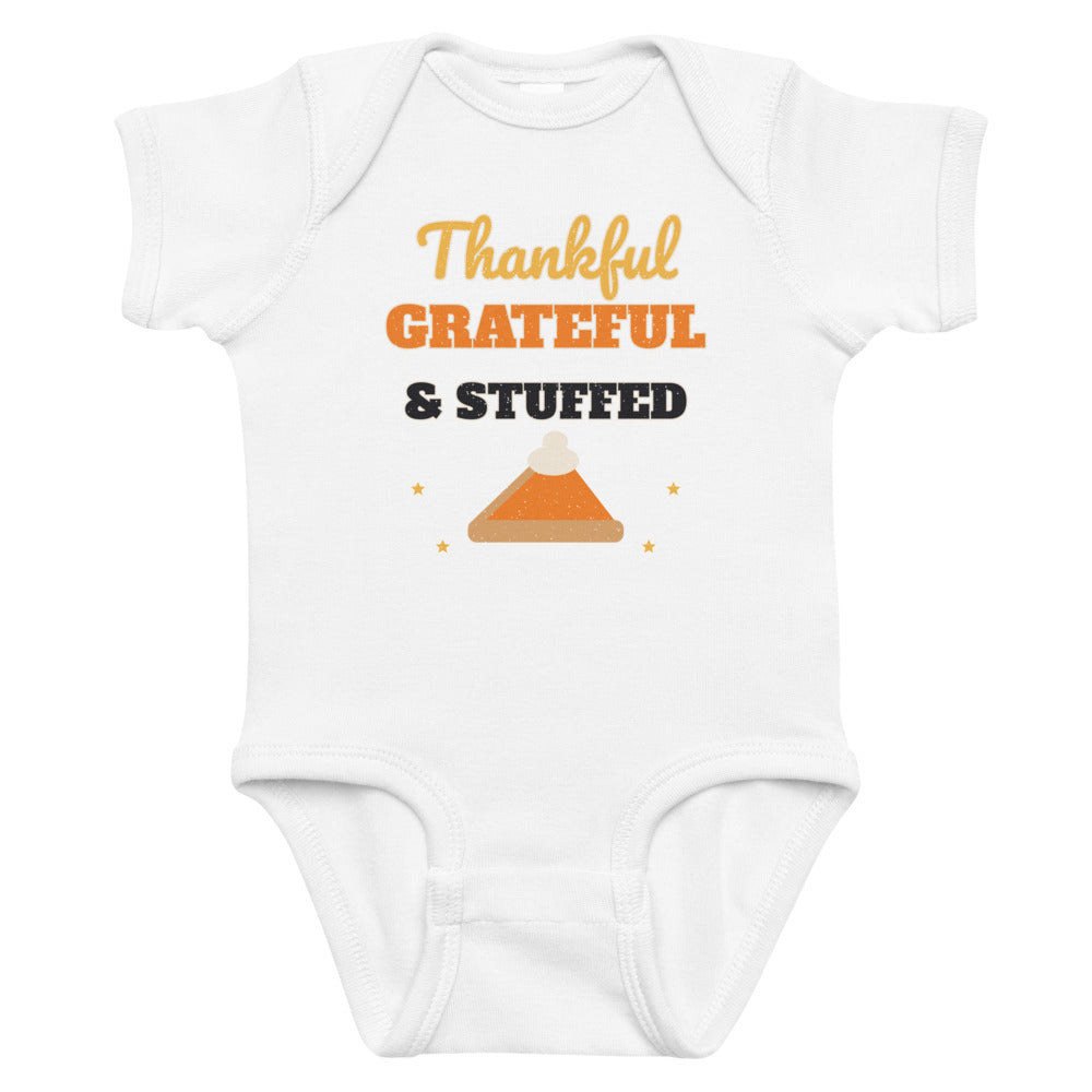 Thankful, Grateful & Stuffed Baby Onesie in white, mockup of the design printed on the front of the baby onesie