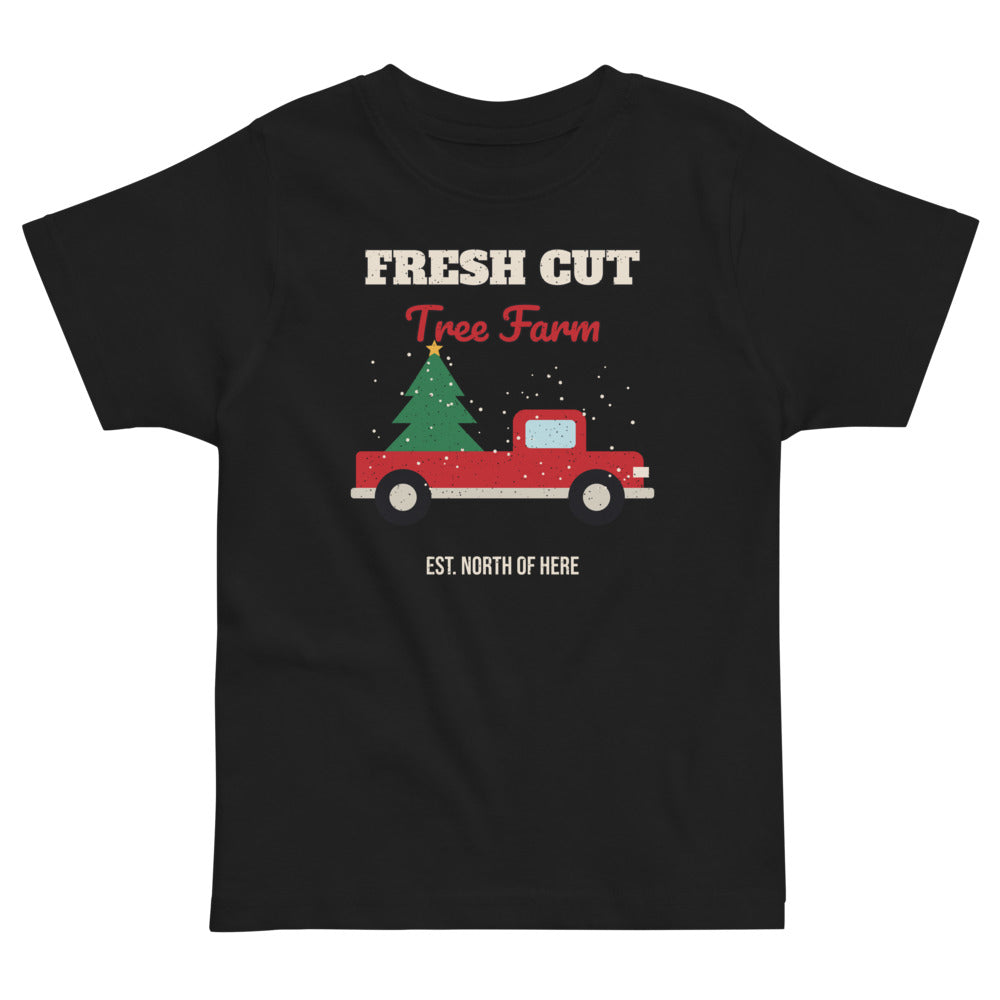 Fresh Cut Tree Farm Toddler Tee in black, mockup of the design printed on the front of the toddler tee