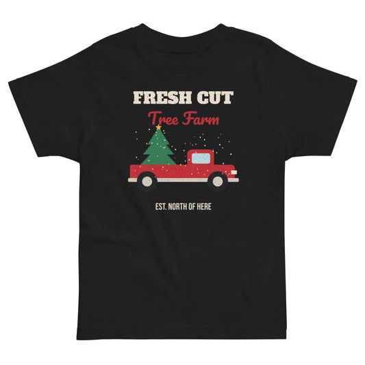 Fresh Cut Tree Farm Toddler Tee in black, mockup of the design printed on the front of the toddler tee