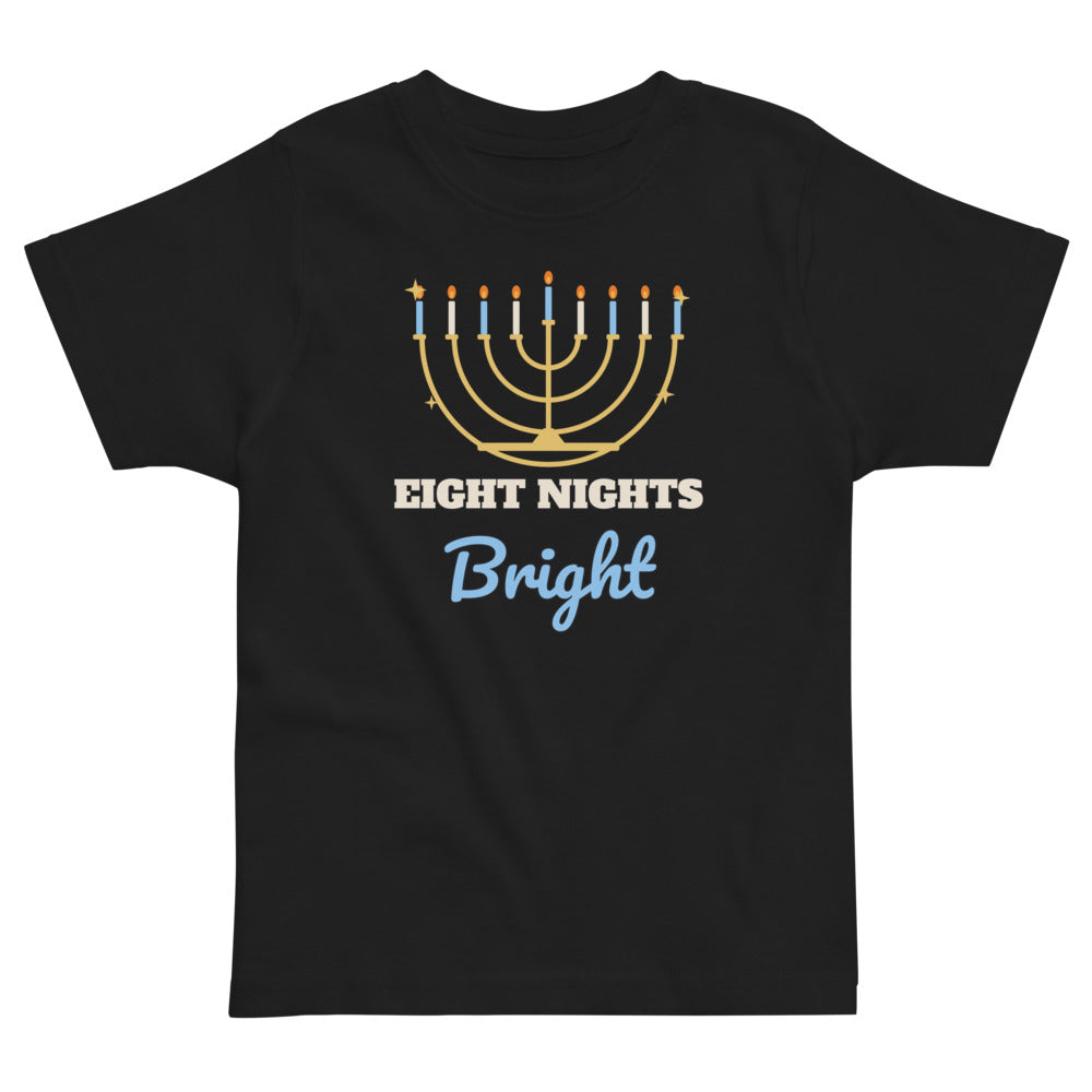 Eight Nights Bright Toddler Tee in black, mockup of the design printed on the front of the toddler tee