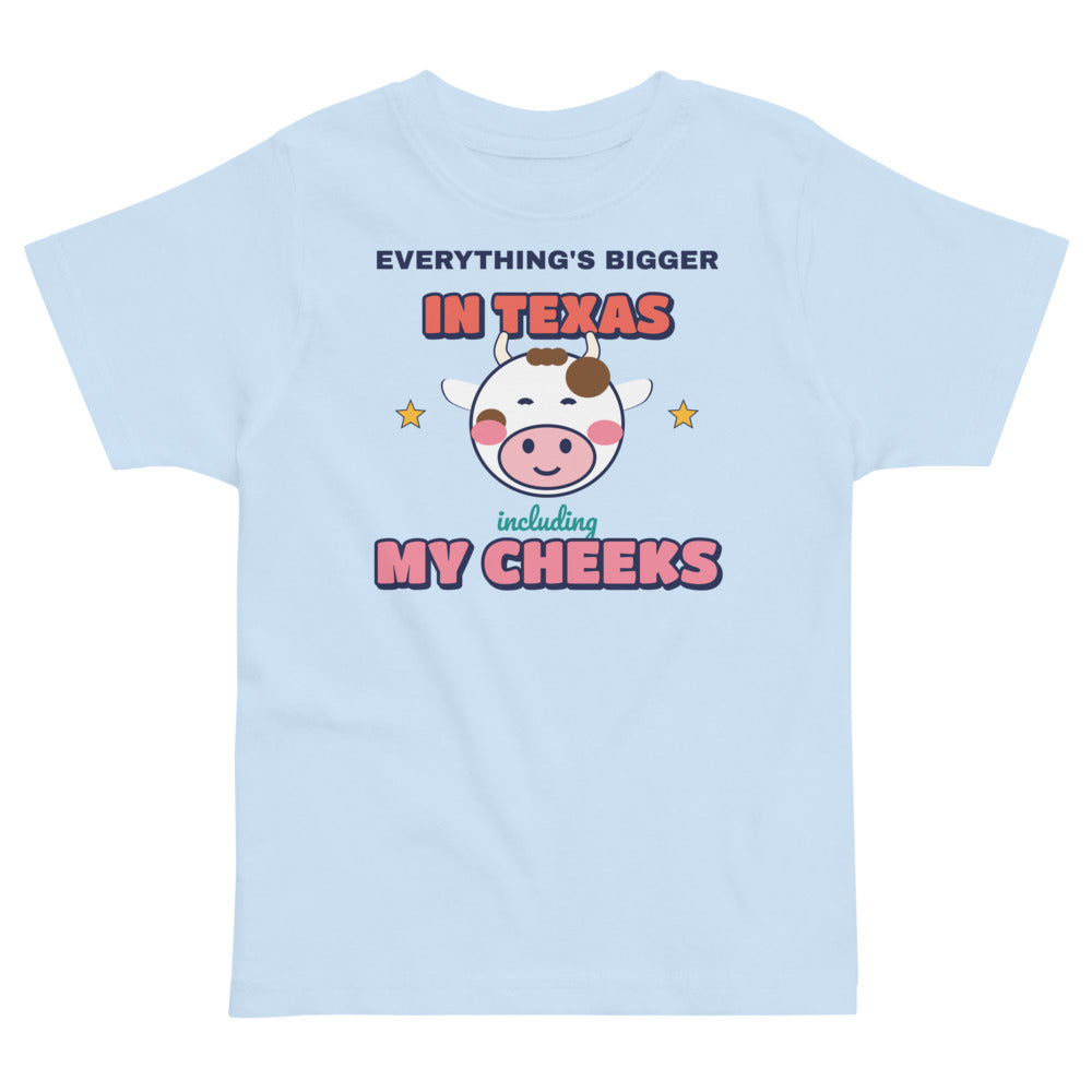 Everything's Bigger in Texas Including My Cheeks Toddler Tee in light blue, mockup of the design printed on the front of the toddler tee