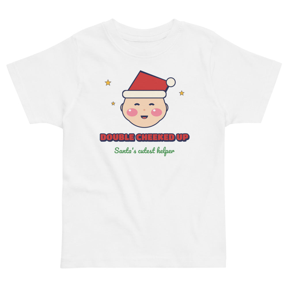 Double Cheeked Up Santa's Cutest Helper Toddler Tee in white, mockup of the design printed on the front of the toddler tee