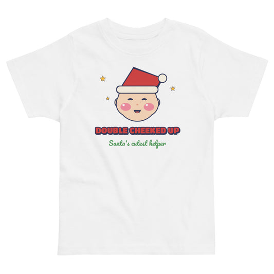 Double Cheeked Up Santa's Cutest Helper Toddler Tee in white, mockup of the design printed on the front of the toddler tee