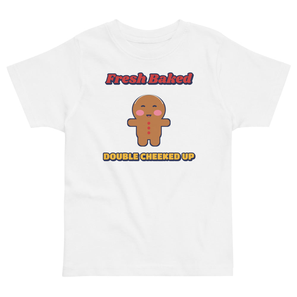 Double Cheeked Up Fresh Baked Gingerbread Toddler Tee in white, mockup of the design printed on the front of the toddler tee