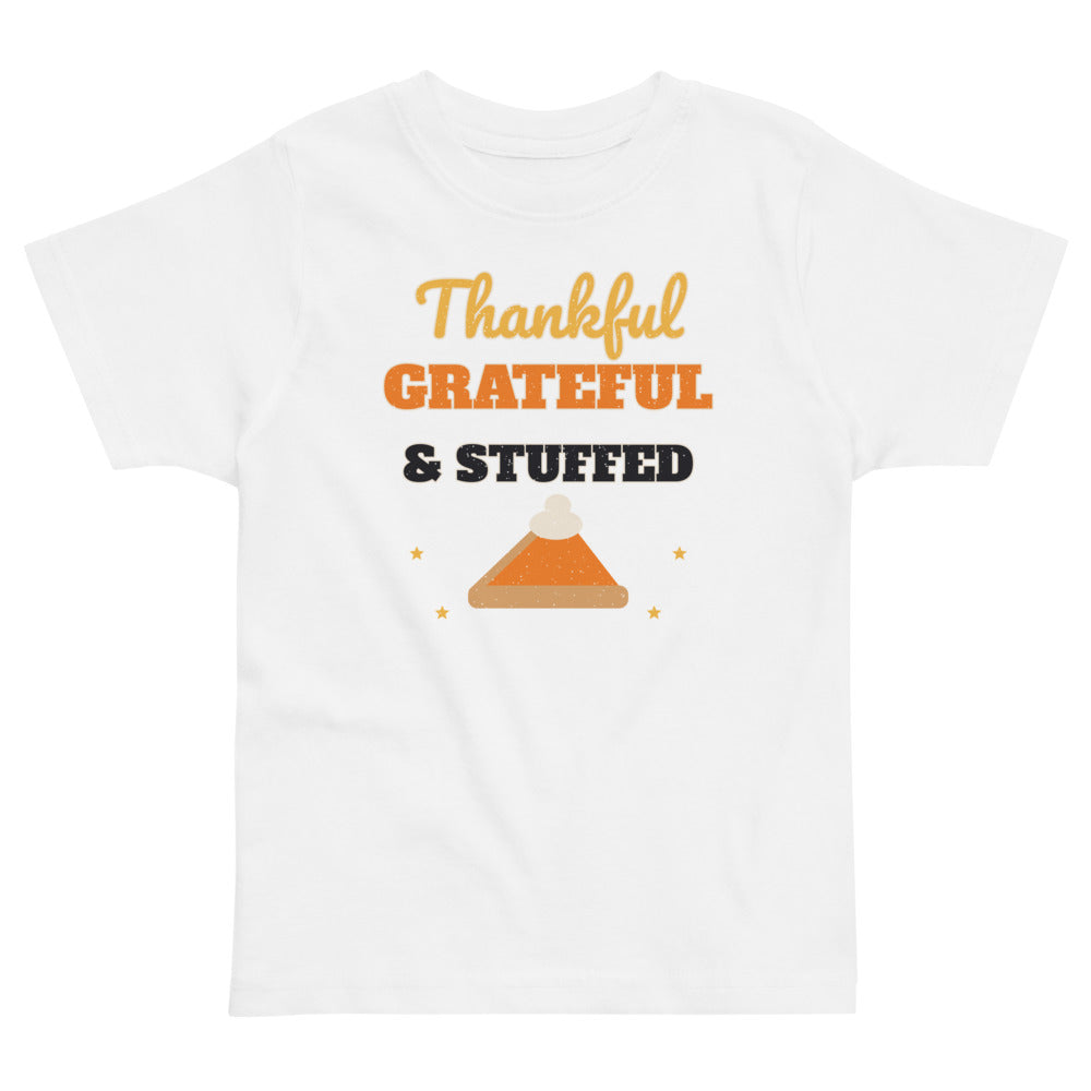 Thankful, Grateful & Stuffed Toddler Tee in white, mockup of the design printed on the front of the toddler tee