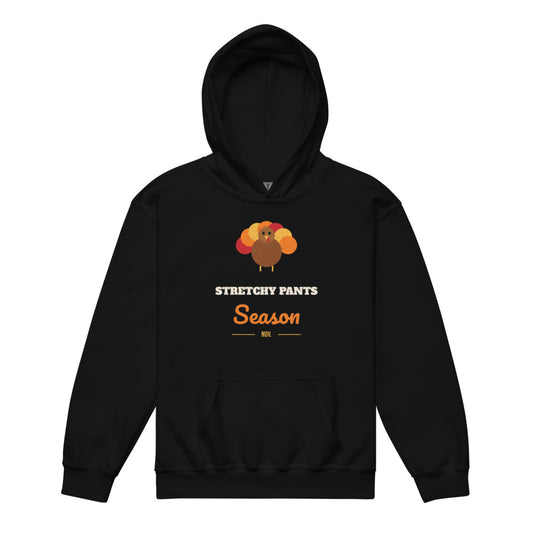 Stretchy Pants Season Kids Hoodie in black, mockup of the design printed on the front of the kids hoodie